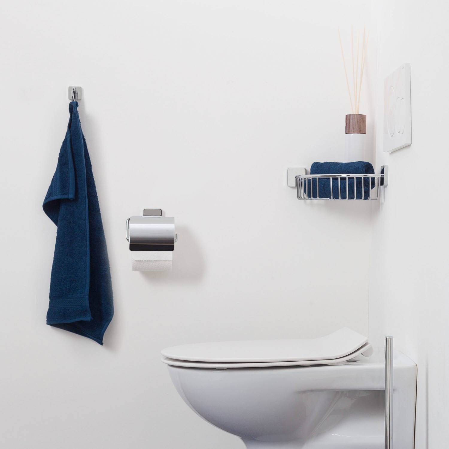 Minimalistyczna łazienka z białym WC i chromem fot. Tiger