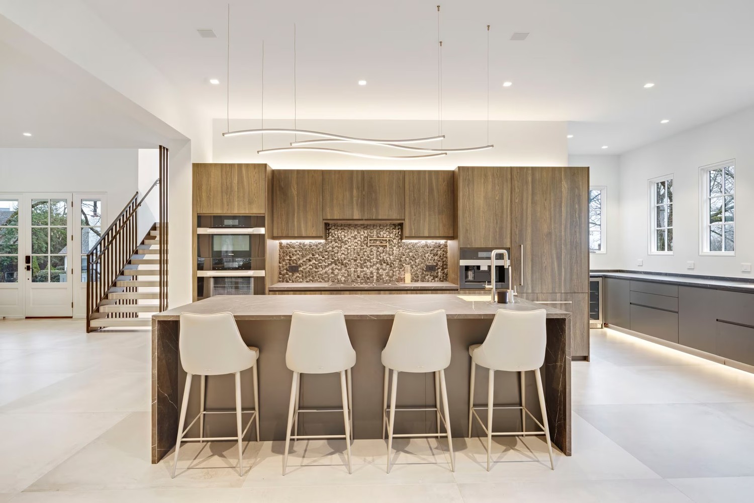 Minimalistyczna kuchnia z wyspą i drewnianą zabudową. fot. Porcelanosa